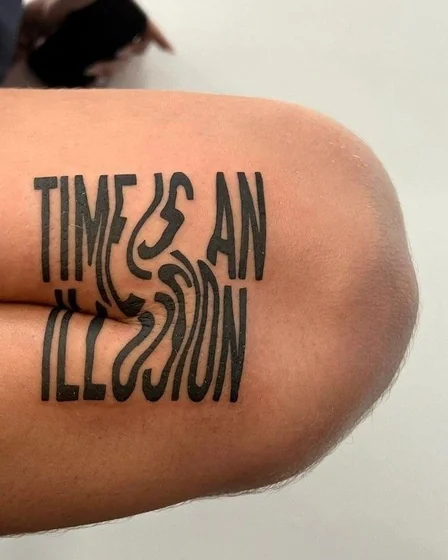 Abstract linework quote tattoo design on upper arm and elbow