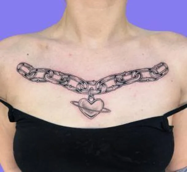 Black And Grey heart and chain tattoo design for women on chest.