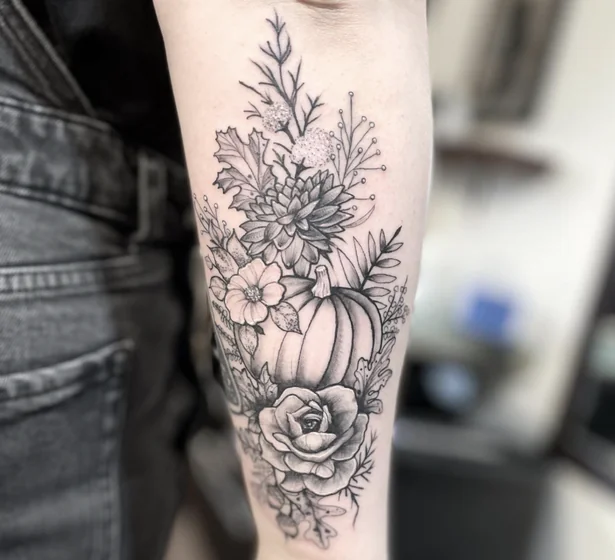 Black & Grey Fine Line Pumpkin & Floral tattoo for ladies on Upper Arm
