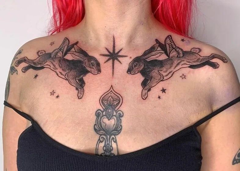 Black and Grey Blackwork winged rabbit and star tattoo design for women on sternum and shoulder