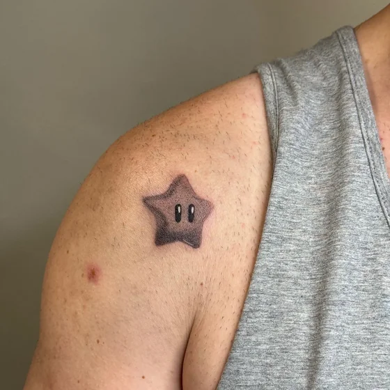 Black and Grey Mario Star video game tattoo idea for men on shoulder