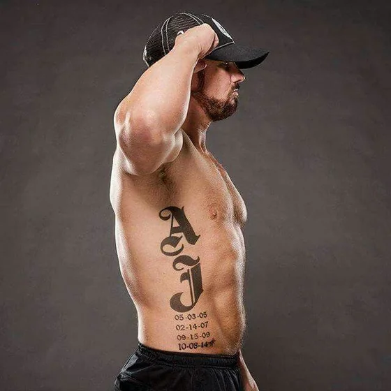 Black and Grey Script Initial and Dates tattoo design for men on Rib