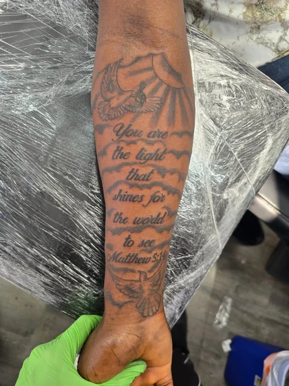 Black and Grey script, dove, sun tattoo design for men on forearm