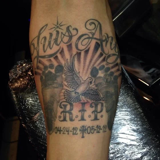 Black and Grey script memorial tattoo idea for men with dove, name, RIP.