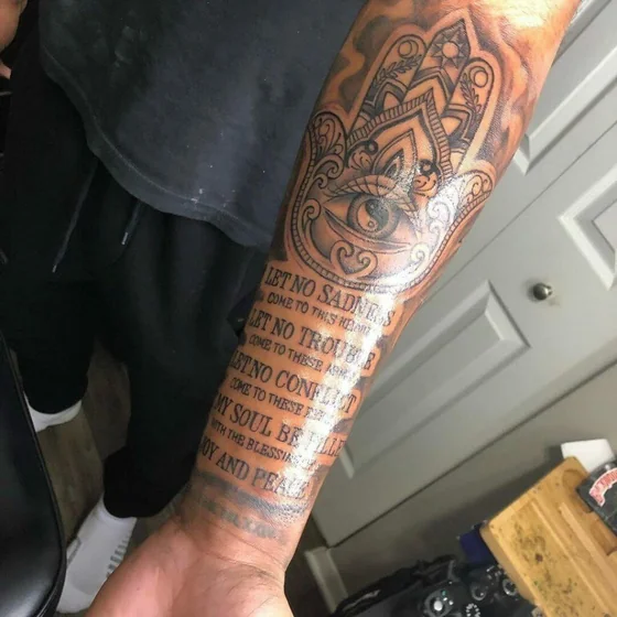 Black and grey Hamsa Hand, Evil Eye, Quote tattoo for men on arm.