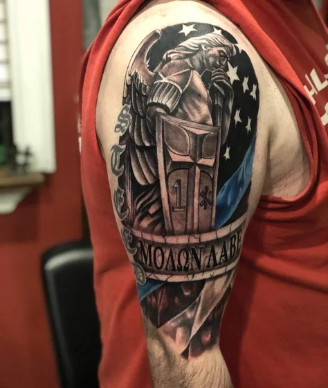 Black and grey Saint Michael angel tattoo for men on upper arm