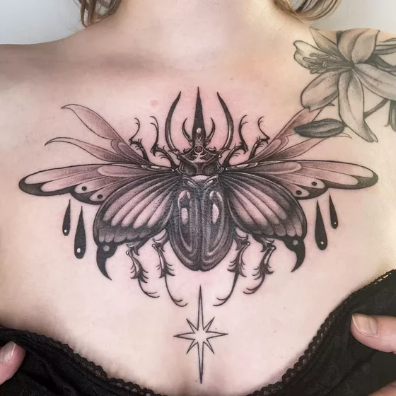 Black and grey beetle, star tattoo design for women on chest