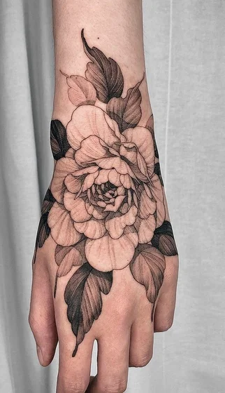 Black and grey fine line floral tattoo design for women on hand
