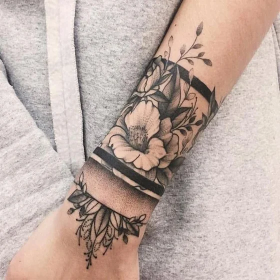 Black and grey fine line floral tattoo for women on forearm