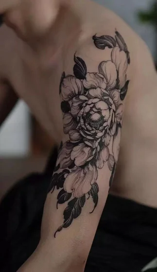 Black and grey floral half sleeve tattoo for men on upper arm