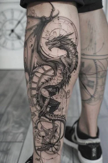 Black and grey realistic dragon & clock tattoo for men on calf