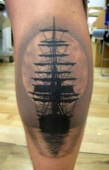Black and grey ship and moon tattoo design for all on calf