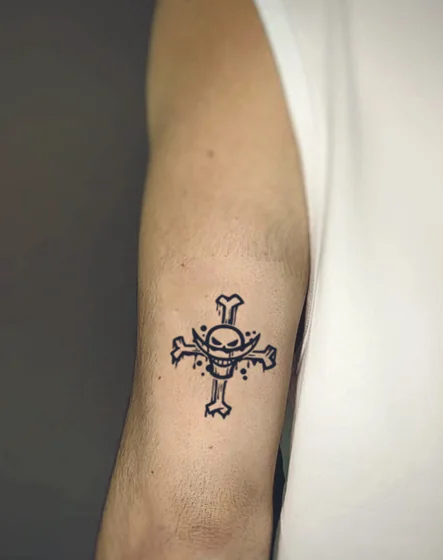 Blackwork One Piece Skull Cross tattoo for men on Upper Arm