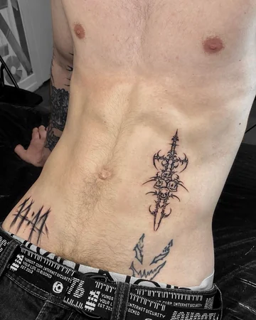 Blackwork Patchwork skull sword thorns tattoo for men on rib and hip tattoo ideas