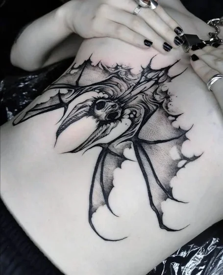 Blackwork and Dotwork bat and skull tattoo idea for women on rib