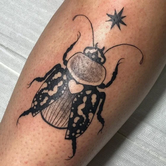 Blackwork beetle and star tattoo design for men and women on calf