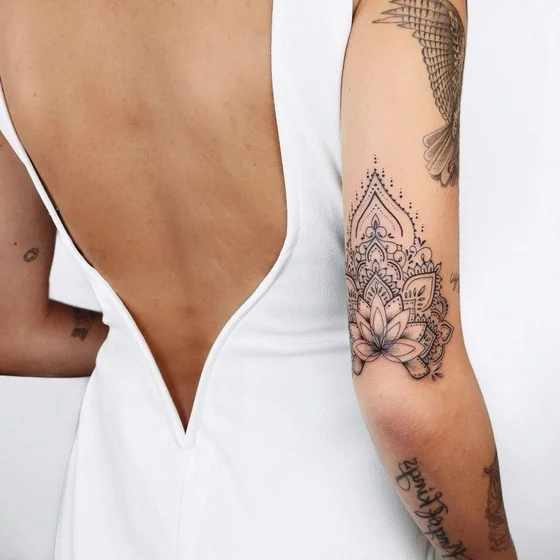 Blackwork dotwork lotus floral tattoo design for women on arm