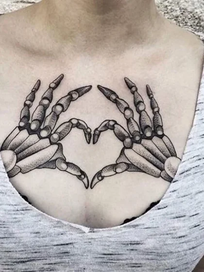 Blackwork dotwork skeleton hands heart tattoo idea for women on chest