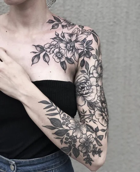 Blackwork fine line floral tattoo for women on shoulder and arm
