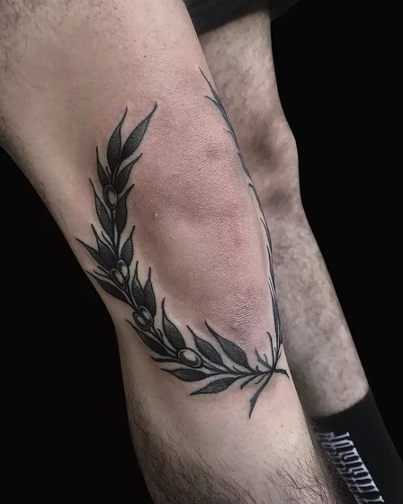 Blackwork floral wreath tattoo design for men on knee
