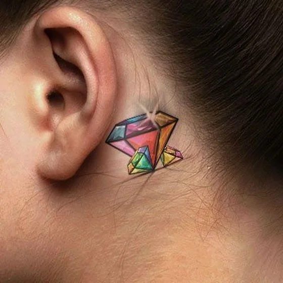 Colorful New School diamond tattoo idea for women behind the ear
