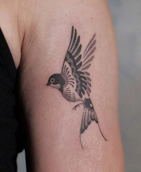 Dotwork fine line bird tattoo idea for women on upper arm