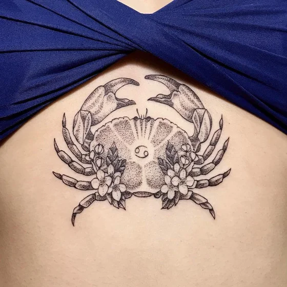 Dotwork fine line crab and floral Cancer tattoo for women.