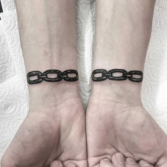 Fine Line Black And Grey Chain tattoo idea for men and women on wrist