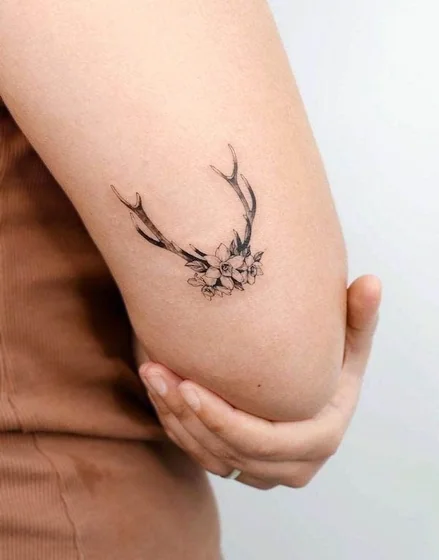 Fine Line Black And Grey deer and floral tattoo design for women on elbow