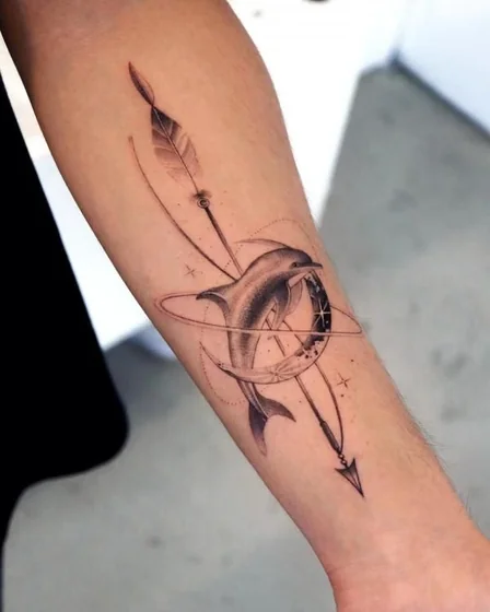 Fine Line Black And Grey dolphin, arrow, moon, compass tattoo design for men on forearm.