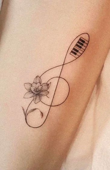 Fine Line Black And Grey flower & Treble Clef tattoo idea for women on arm