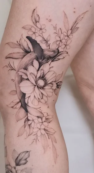 Fine Line Black And Grey whale and floral tattoo idea for women on thigh