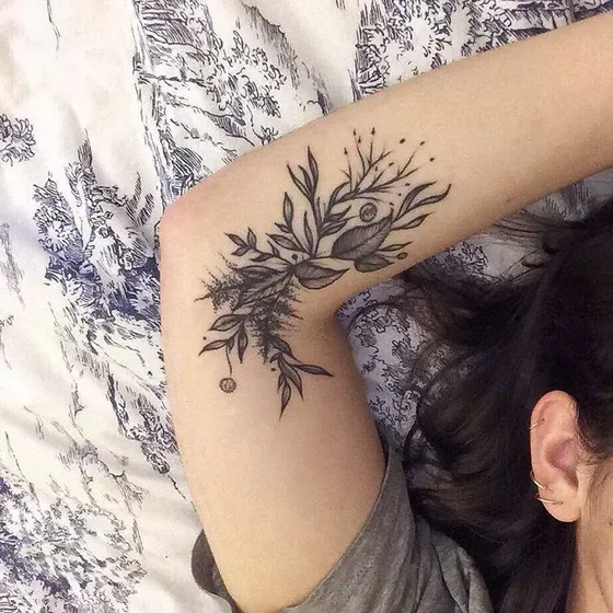 Fine Line Blackwork floral tattoo design for women on upper arm