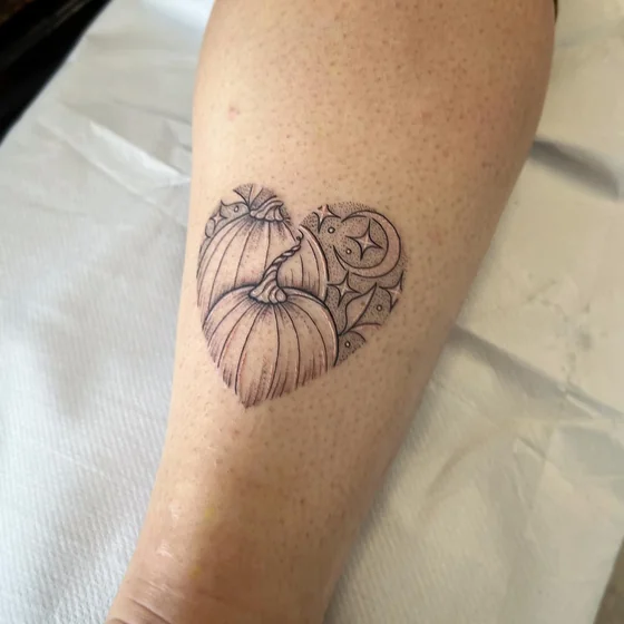 Fine Line Dotwork Heart Pumpkin tattoo design for women on calf