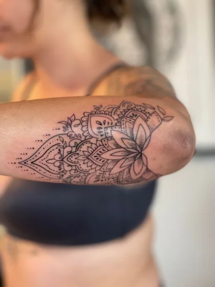 Fine Line Dotwork Mandala Floral tattoo design for ladies on Upper Arm