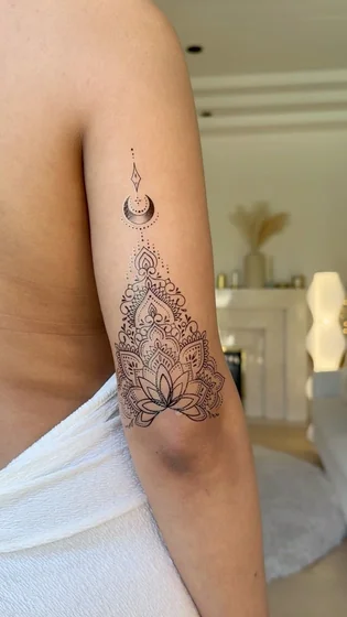 Fine Line Dotwork Moon Lotus Floral tattoo idea for women on Upper Arm