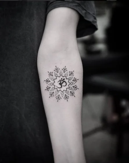 Fine Line Dotwork Om Mandala tattoo design for women on forearm