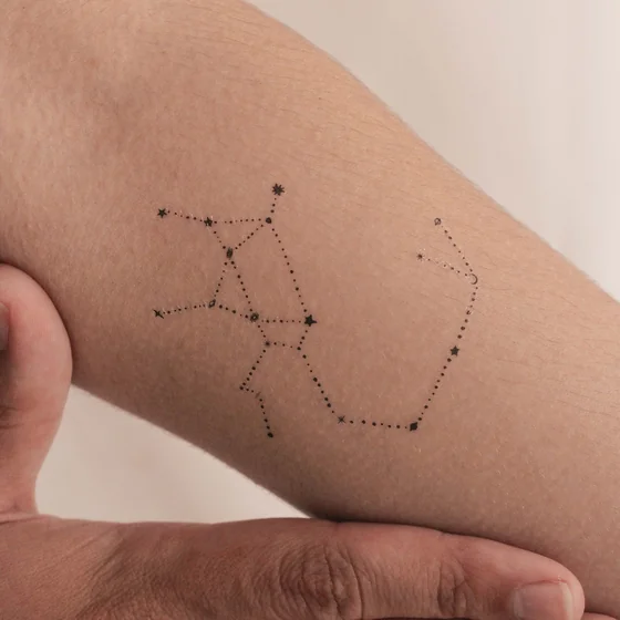 Fine Line Dotwork Sagittarius constellation tattoo idea for men & women on forearm