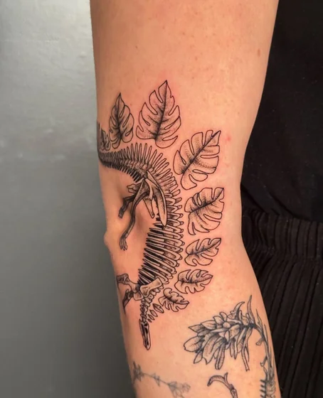 Fine Line Dotwork dinosaur and floral tattoo for women on arm