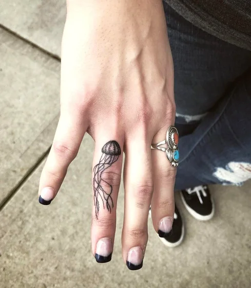 Fine Line Jellyfish tattoo design for women on finger