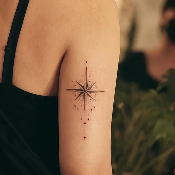Fine Line Minimalist Compass tattoo design for women on upper arm