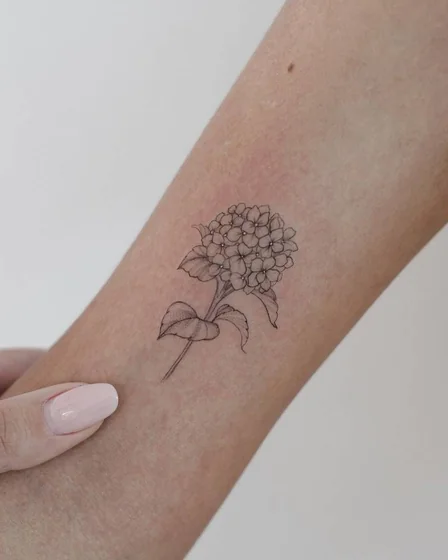 Fine Line Minimalist Floral tattoo idea for women on forearm