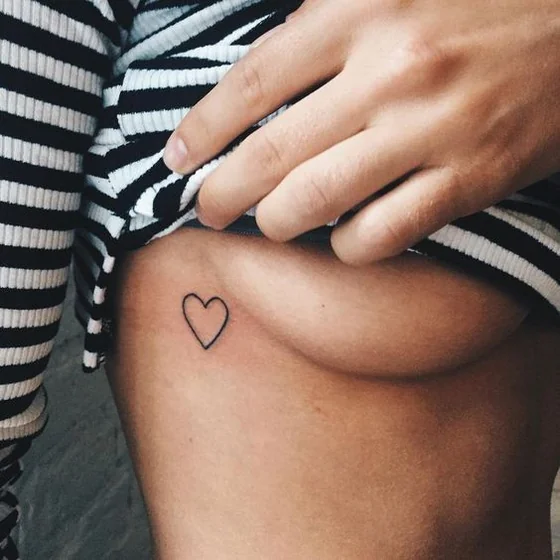 Fine Line Minimalist Heart tattoo idea for women on Rib