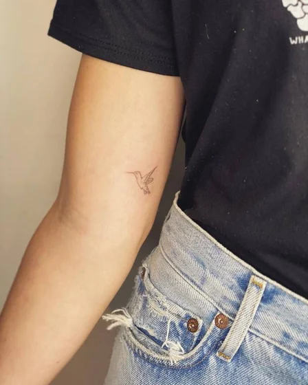 Fine Line Minimalist Hummingbird tattoo design for women on Upper Arm