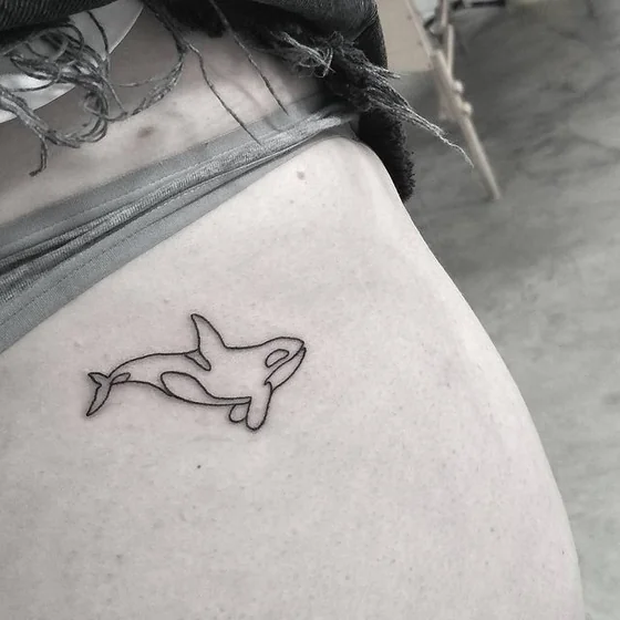 Fine Line Minimalist Orca tattoo design for women on hip