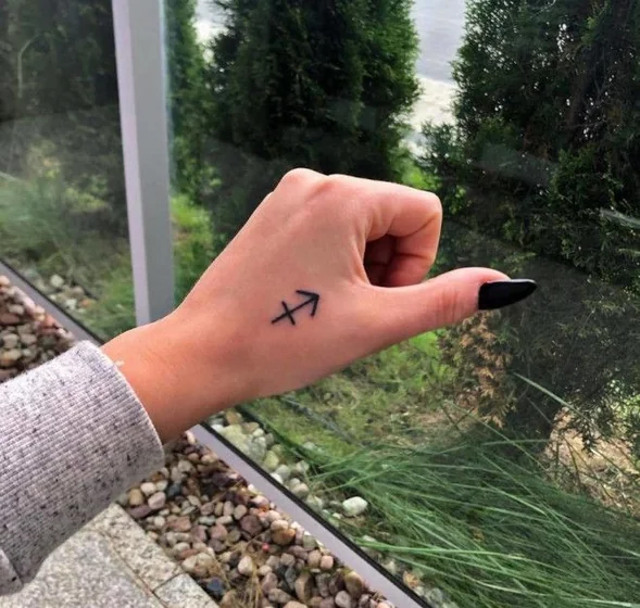 Fine Line Minimalist Sagittarius tattoo design for women on Hand