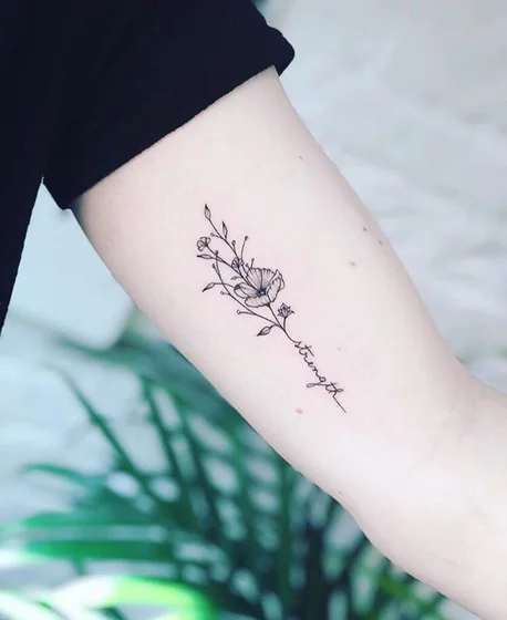 Fine Line Minimalist floral and quote tattoo design for women on forearm