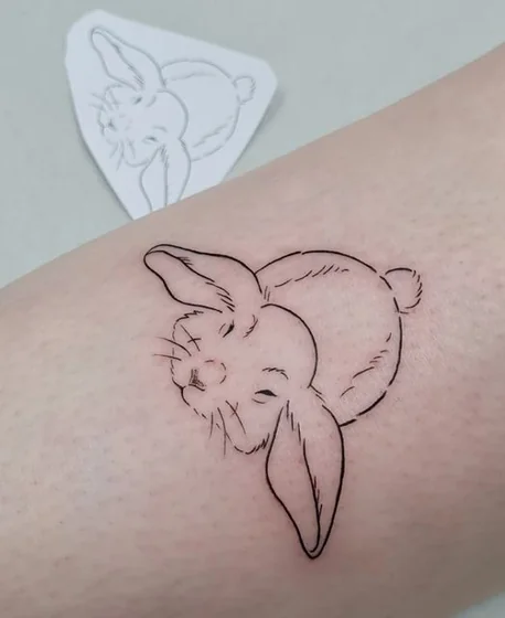 Fine Line Minimalist rabbit tattoo design for women on leg