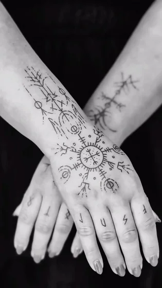 Fine Line Patchwork Viking Nordic Vegvisir Runes tattoo for women on forearm and hand.