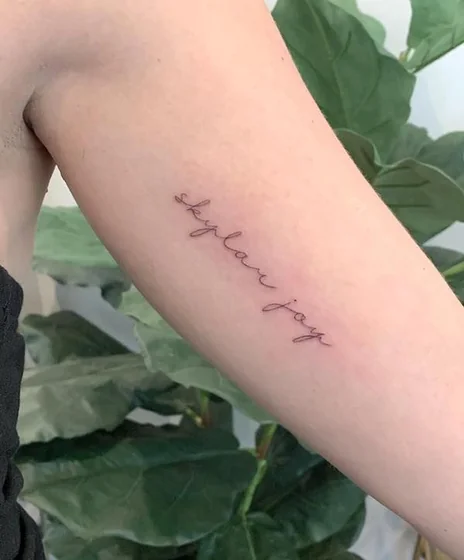 Fine Line Script Name tattoo design for women on Upper Arm